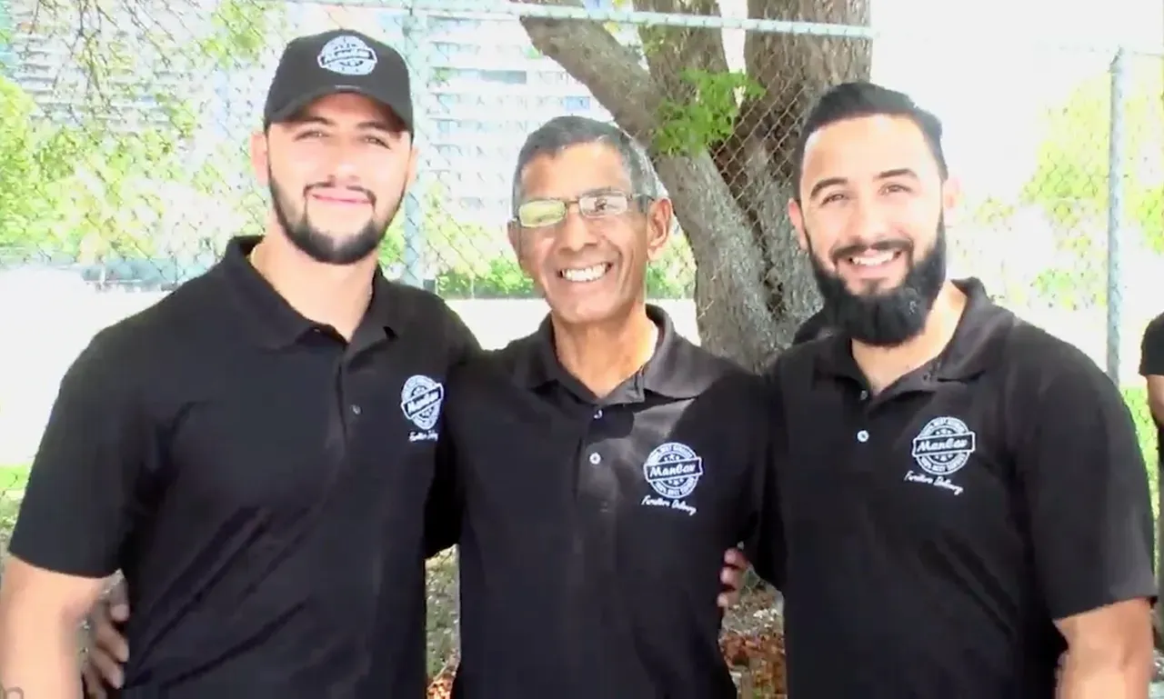 Three ManCav Movers team members in black company polo shirts
